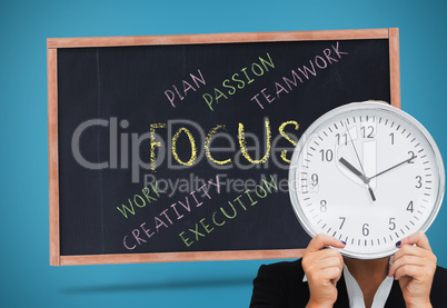 Composite image of businesswoman in suit holding a clock