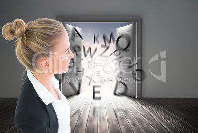 Composite image of businesswoman standing with hands on hips