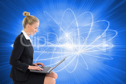 Composite image of businesswoman using laptop