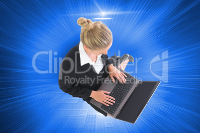 Composite image of businesswoman using laptop