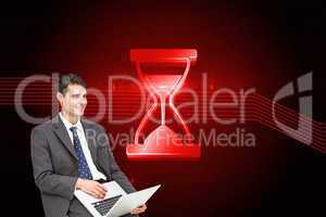 Composite image of businessman using laptop