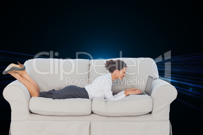 Composite image of business woman lying on couch