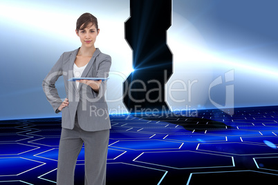 Composite image of attractive businesswoman holding tablet pc