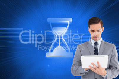 Composite image of businessman holding a tablet computer