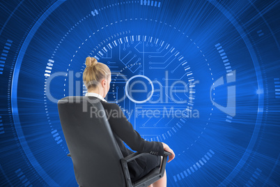 Composite image of businesswoman sitting on swivel chair in blac