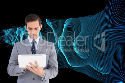 Composite image of businessman holding a tablet computer