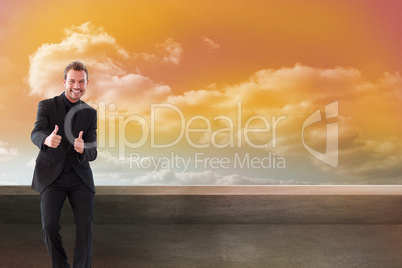 Composite image of businessman with thumbs up in a meeting