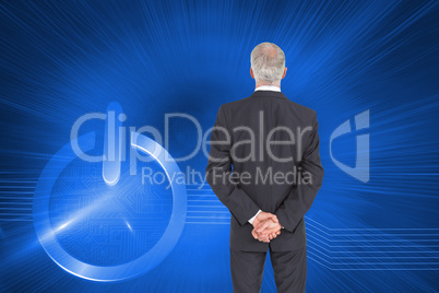 Composite image of rear view of serious businessman posing