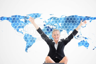 Composite image of businesswoman sitting in front of laptop with