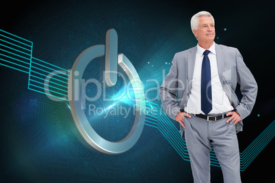 Composite image of man in a suit with his hands on his hips