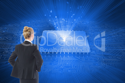 Composite image of businesswoman standing with hands on hips