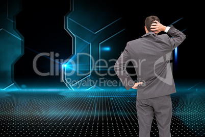 Composite image of young businessman standing back to camera scr