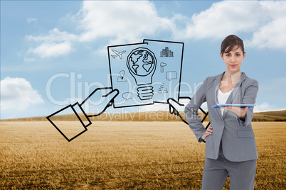 Composite image of attractive businesswoman holding tablet pc