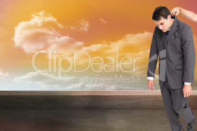 Composite image of businessman hanging