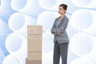 Composite image of thoughtful woman with cardboard boxes