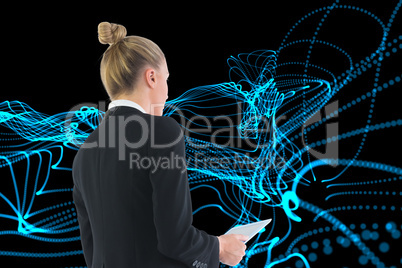 Composite image of businesswoman holding tablet