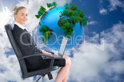 Composite image of businesswoman sitting on swivel chair with la