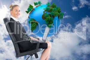 Composite image of businesswoman sitting on swivel chair with la