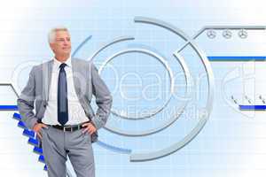 Composite image of man in a suit with his hands on his hips