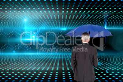 Composite image of businessman holding umbrella