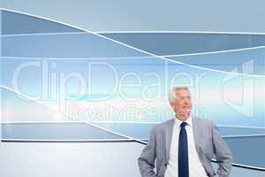 Composite image of man in a suit with his hands on his hips