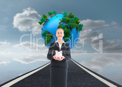 Composite image of businesswoman holding pink piggy bank