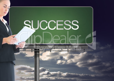 Composite image of businesswoman holding tablet