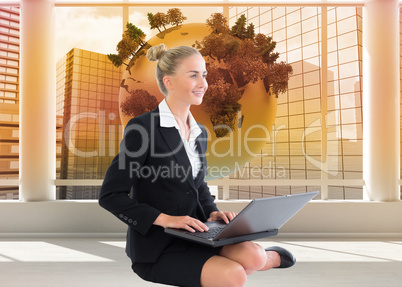 Composite image of businesswoman using laptop