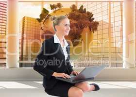 Composite image of businesswoman using laptop