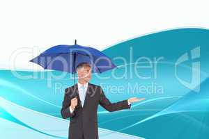 Composite image of happy businessman holding umbrella