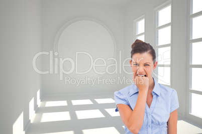 Composite image of furious businesswoman looking at the camera