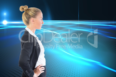 Composite image of businesswoman standing with hands on hips