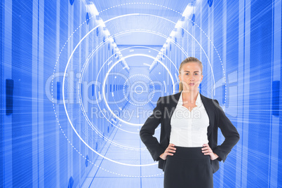 Composite image of businesswoman standing with hands on hips