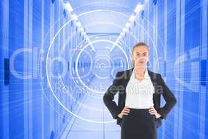 Composite image of businesswoman standing with hands on hips