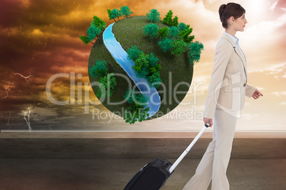 Composite image of serious businesswoman pulling suitcase