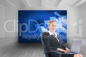 Composite image of businesswoman sitting in swivel chair with la