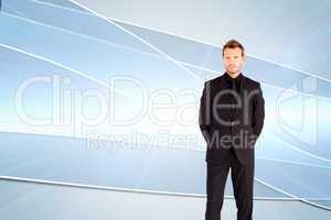 Composite image of young businessman looking at the camera