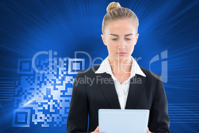 Composite image of businesswoman holding tablet