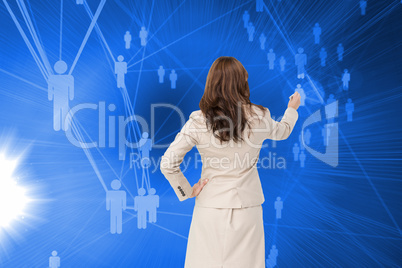 Composite image of businesswoman standing back to camera writing