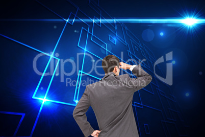 Composite image of businessman standing hand on hip