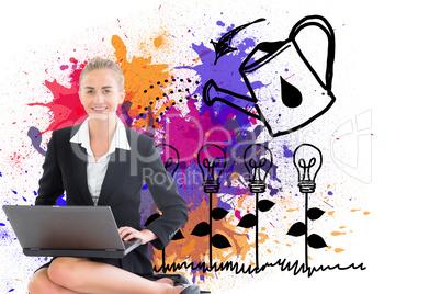 Composite image of businesswoman using laptop