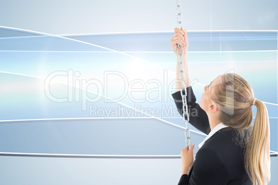 Composite image of businesswoman pulling a chain