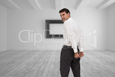 Composite image of rear view of young businessman wearing handcu