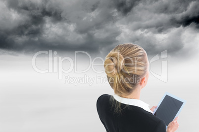 Composite image of businesswoman holding new tablet