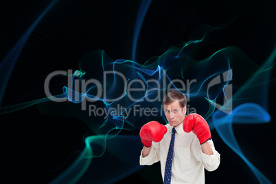 Composite image of businessman with his boxing gloves ready to f