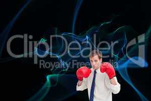 Composite image of businessman with his boxing gloves ready to f