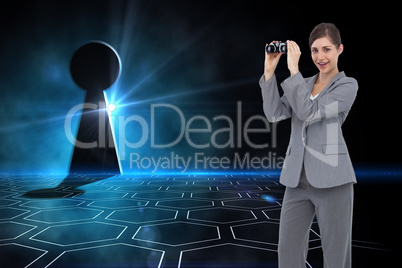 Composite image of businesswoman posing with binoculars