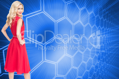 Composite image of smiling blonde standing hands on hips