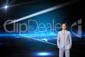 Composite image of attractive businessman with hands in pockets