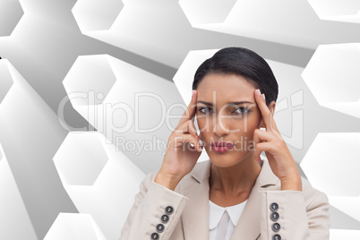 Composite image of young businesswoman putting her fingers on he